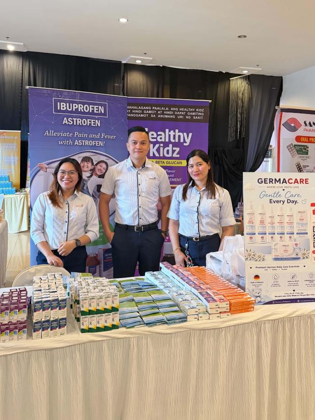 Nurturemed representatives beside the Astrofen display at the Davao Regional Medical Center pediatrics postgraduate course