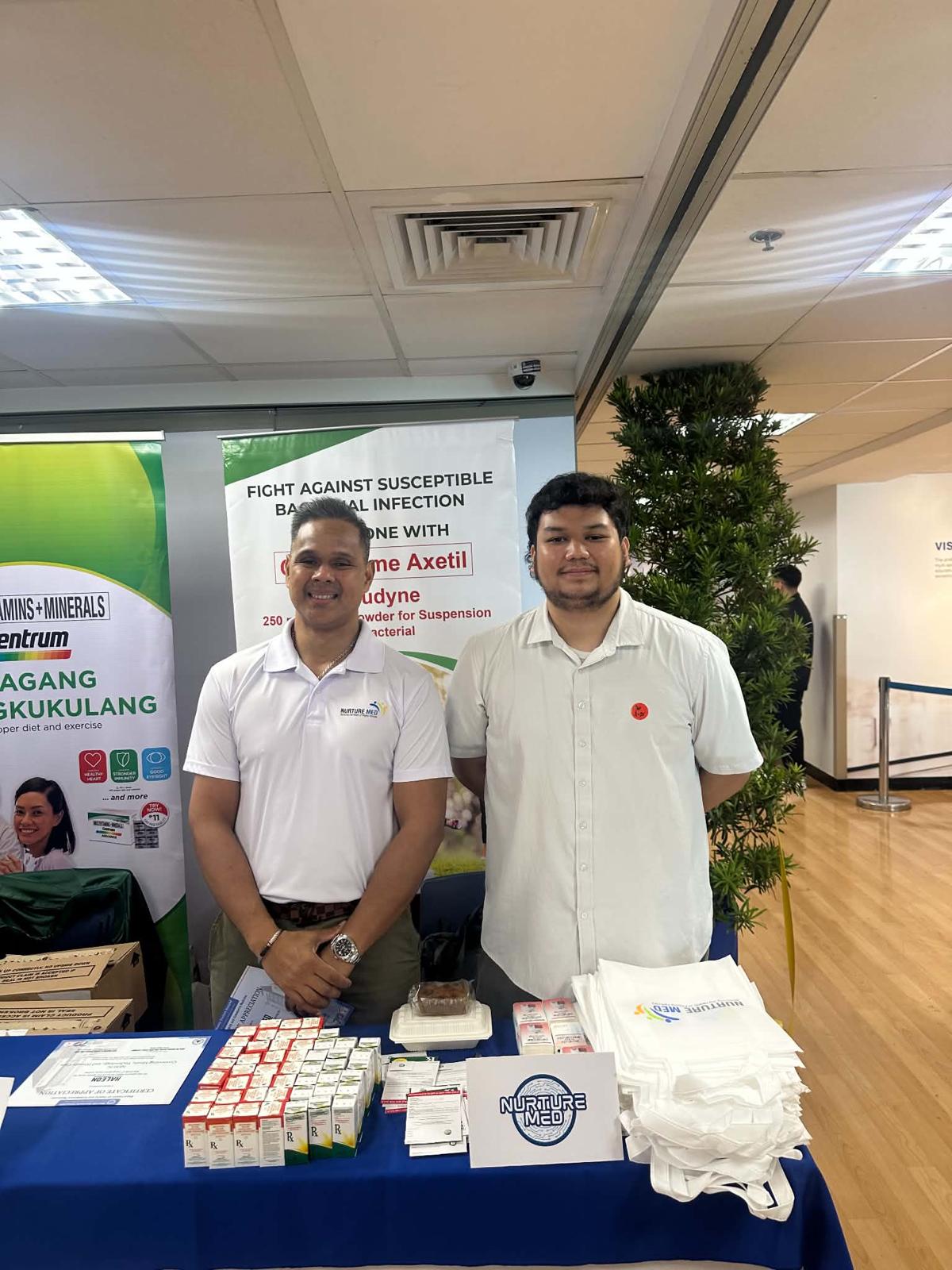 Nurturemed representatives behind a product display at the Manila Doctors Hospital family and community medicine postgraduate course