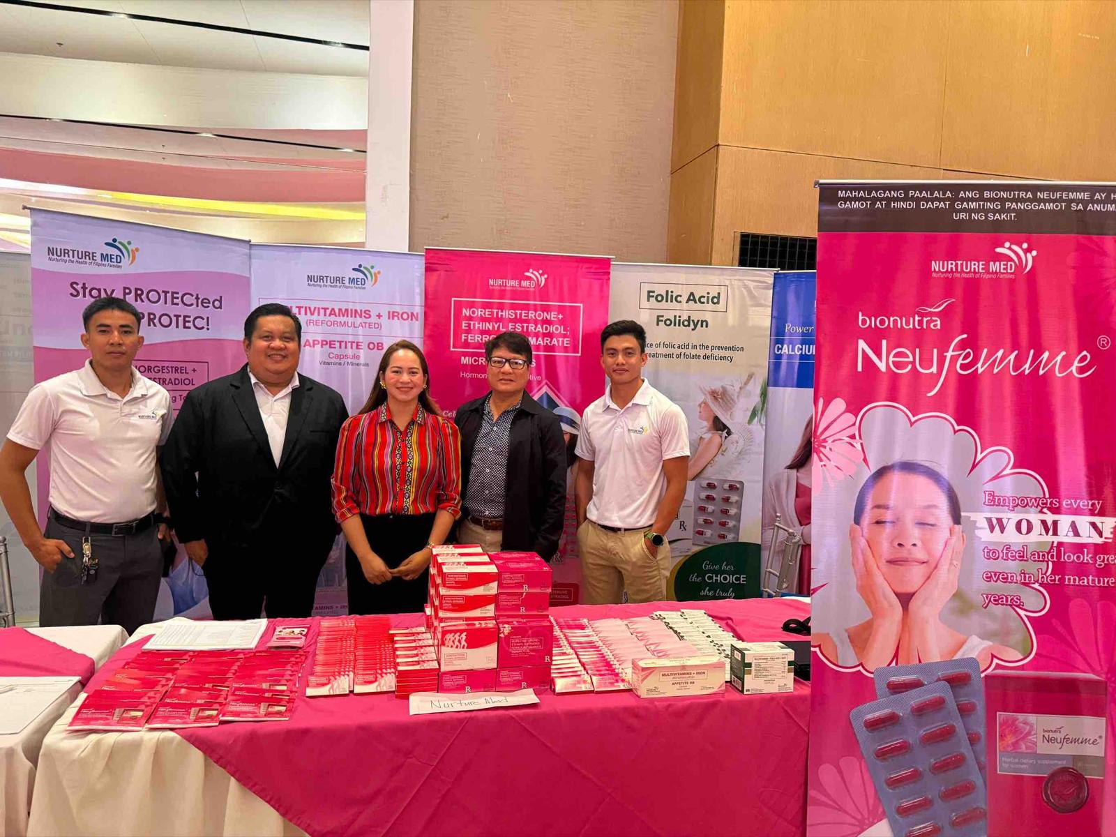Nurturemed representatives beside the Bionutra Neufemme display at the Western Mindanao OB-GYNE postgraduate course